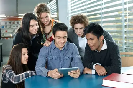 group-of-teens-around-an-ipad.webp